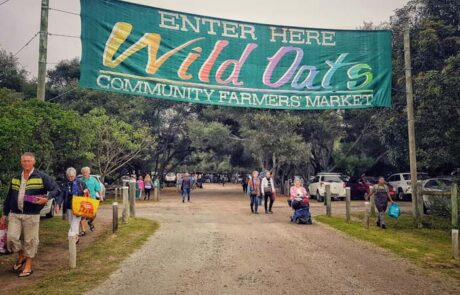 3. Meet Locals – Wild Oats Market Sign